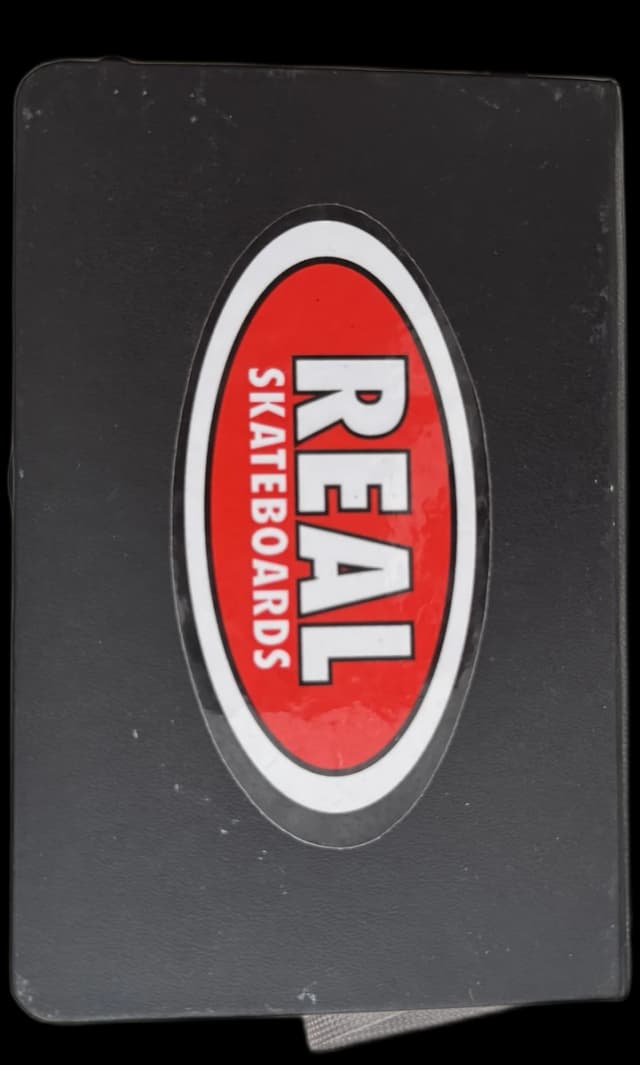 black sketchbook with a real skateboards sticker
